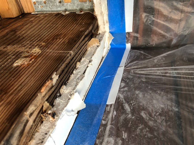 Ceiling water damage in living room located below tile deck leak